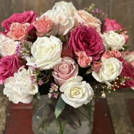Bouquet of pink and white roses in a glass vase