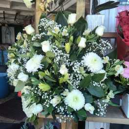 White floral arrangement with roses, lilies, and chrysanthemums