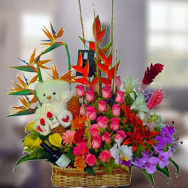 Colorful flower basket with a teddy bear and tropical blooms