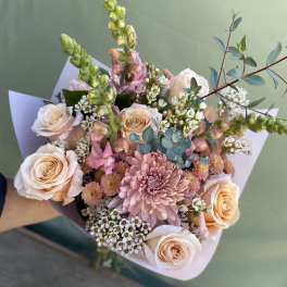 Bouquet of blush roses and pink blooms with eucalyptus