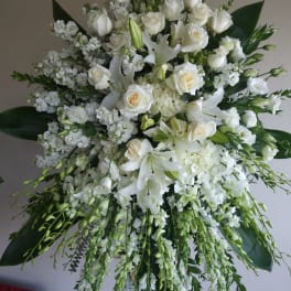White roses and lilies in a large standing arrangement