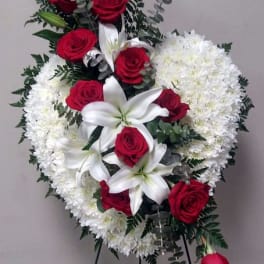 Standing floral wreath with red roses, white lilies, and white chrysanthemums