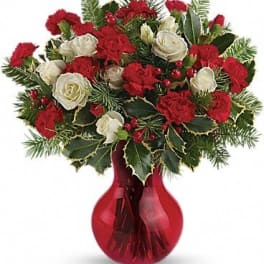 Red and white floral arrangement in a red vase