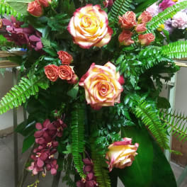 Standing floral spray with yellow-edged roses and burgundy orchids