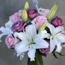 Bouquet of pink and purple roses with white lilies