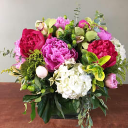 Bright mixed bouquet with pink peonies, white hydrangea, and green accents in a vase
