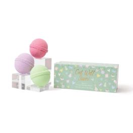 Three pastel bath bombs beside a green gift box labeled Get Well Soon.