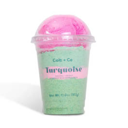 Pink and mint bath product in a clear plastic cup with a dome lid