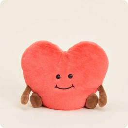 Heart-shaped pink plush toy with a smiling face and small brown feet