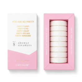 Pink and white box of shower steamers with stacked round tablets