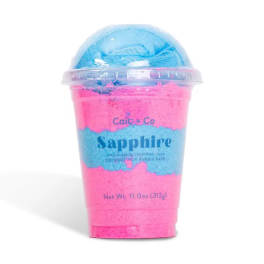 Pink and blue bath product in a clear cup with a dome lid
