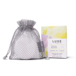 Mesh drawstring pouch beside a boxed shower steamer