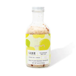 Bottle of jasmine tea and ginger bath soak with a colorful label