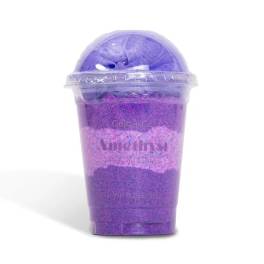 Purple bath product in a clear plastic cup with a domed lid