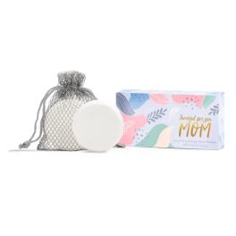 Soap bar in a mesh bag beside a pastel gift box for mom