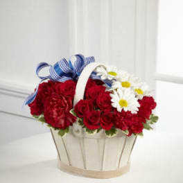 Basket of red roses and white daisies with blue ribbon