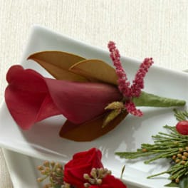 Red calla lily arrangement with pink accents on a white tray