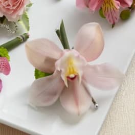 Pink orchid corsage with ribbon and pearl accents