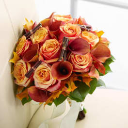 Bouquet of orange and yellow roses with dark calla lilies