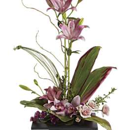 Tall floral arrangement with pink lilies and orchids in a black vase
