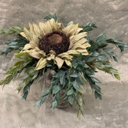 Sunflower arrangement in a vase with cascading greenery