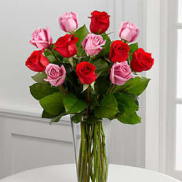 Bouquet of red and pink roses in a clear glass vase