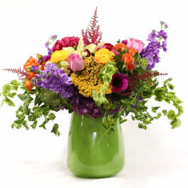 Colorful mixed bouquet in a green vase