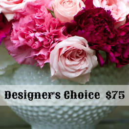 Pink and white roses with magenta carnations in a white vase