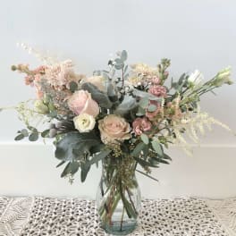 Blush and white flower bouquet in a clear glass vase