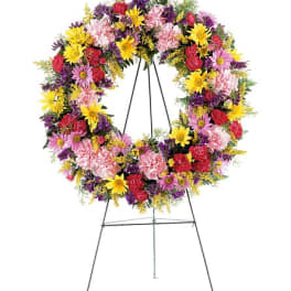 Colorful mixed flower wreath on a standing easel