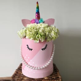 Pink unicorn-themed hat box with hydrangeas and a rainbow horn