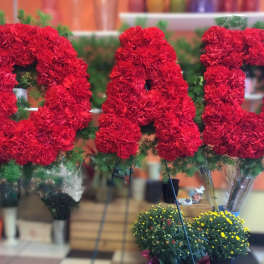 Large red floral letters spelling DAD with greenery accents