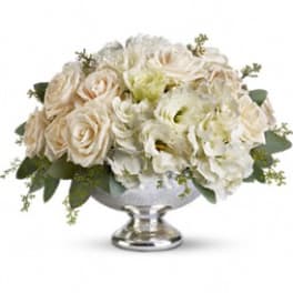White and cream floral arrangement in a silver pedestal vase