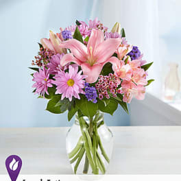 Pink and purple mixed bouquet in a clear glass vase
