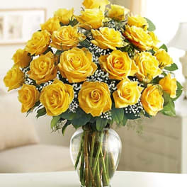 Yellow roses arranged in a clear glass vase
