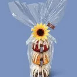 Gift tower wrapped in clear cellophane with a sunflower topper