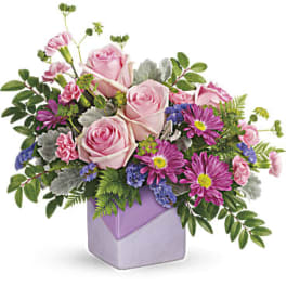 Pink roses and purple daisies in a lavender vase