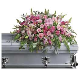 Pink floral casket spray with roses and lilies