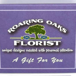 Purple florist gift box with a Roaring Oaks Florist logo and text