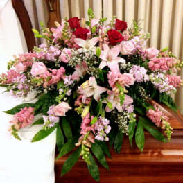 Large pink and white floral casket spray with roses and lilies