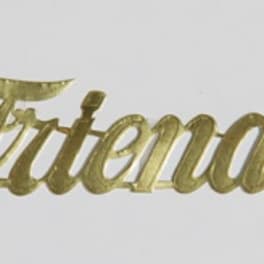 Gold script sign reading "Friends" on a white background