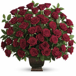 Large bouquet of red roses in a dark vase