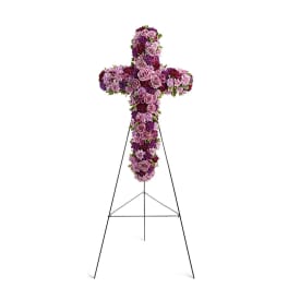 Purple floral cross on a black stand