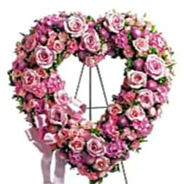 Heart-shaped standing wreath of pink roses on an easel