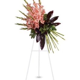 Pink gladiolus arrangement on a white easel