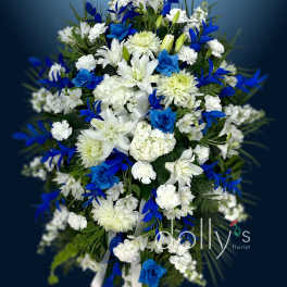 Blue and white funeral spray with lilies and chrysanthemums