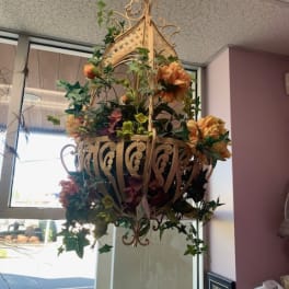 Hanging floral basket with orange blooms and ivy