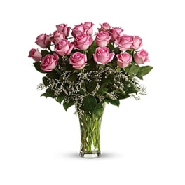Pink roses arranged in a clear glass vase