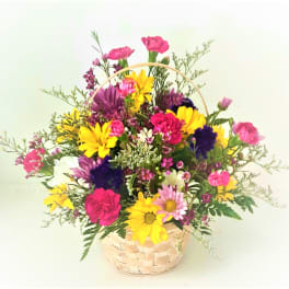Colorful mixed bouquet in a woven basket