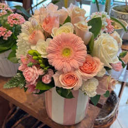 Pink and white mixed flower bouquet in a striped vase